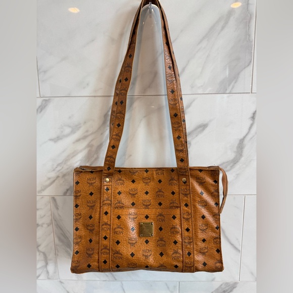 MCM Handbags - Authentic Large MCM Brown Leather Long Strand Bag with Iconic Monogram Design